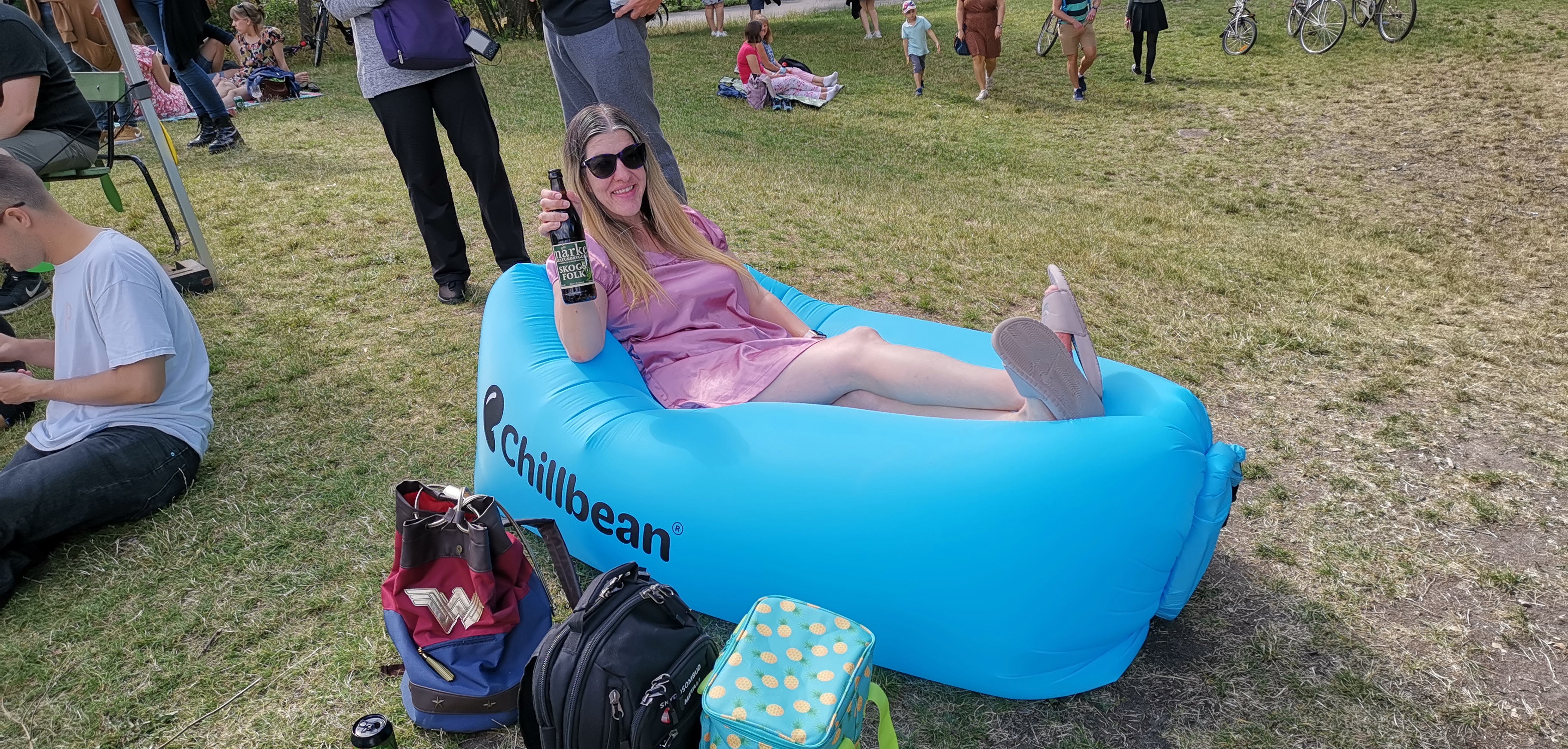 Woman sitting in a Chillbean air lounger holding a Närke Kulturbryggeri beer at Popaganda music festival in Stockholm Sweden